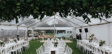 Tables set for a wedding under the marquee