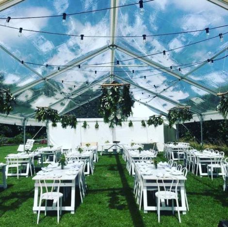 Tables and chairs set out in the marquee