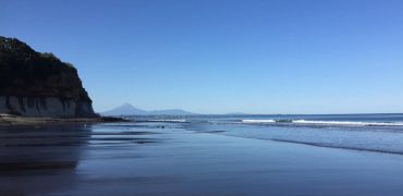 The beach at Wai-iti with Mount Taranaki in the distance